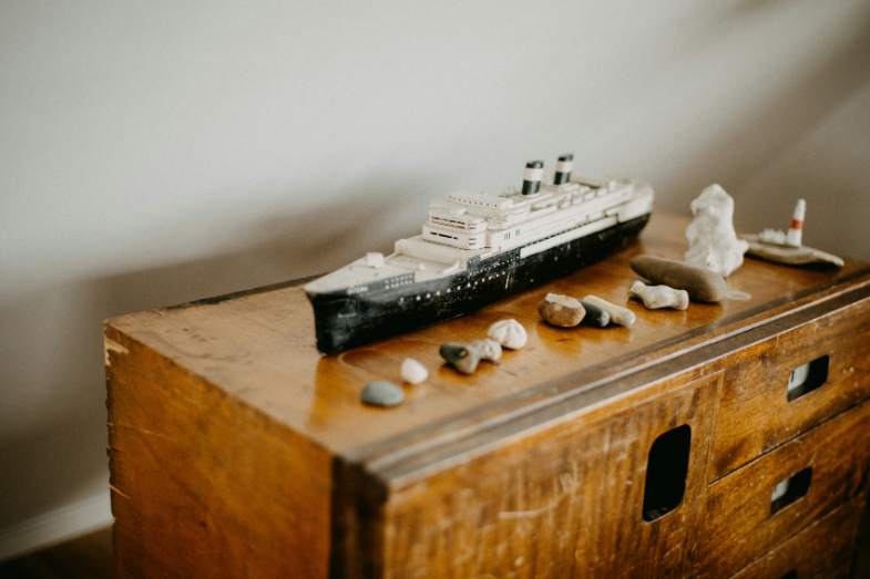 a model of a ship on an oak dresser, sourced by Tweed & Toad Co.
